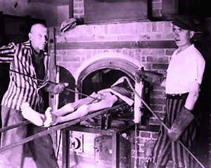 Two workers demonstrate pushing the emaciated body of a man into a crematorium oven at Dachau concentration camp after their liberation by the US army.