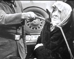 An elderly Polish Jewish woman is shown being humiliated and brutalized by a Nazi SS officer in Poland in 1940.