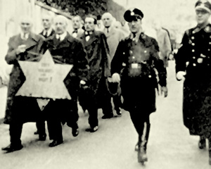 Jewish men in Germany are rounded up and marched straight off to the Nazi concentration camps at Dachau, Buchenwald, and Sachsenhausen after the November 1938 ‘Crystal Night’.