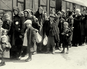 Jewish families from Hungary disembark from the railway cattle cars that had transported them across Europe to an almost certain death at the Auschwitz-Birkenau death camp in Poland during World War Two.